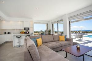 a living room with a couch and a table at Your House In Rhodes in Afantou