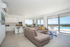 a living room with a couch and a kitchen at Your House In Rhodes in Afantou +35 photos