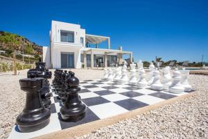a chess board on the beach in front of a house at Your House In Rhodes in Afantou