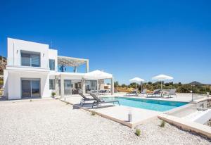 a large white house with a swimming pool at Your House In Rhodes in Afantou