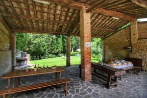 an outdoor patio with a table and a fireplace at Agriturismo Bellavista in Radicondoli