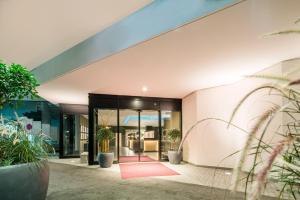 a building with a red rug in front of it at Best Western Premier Central Hotel Leonhard in Feldkirch