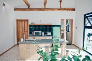 a kitchen with wooden cabinets and a green refrigerator at Hidden in the World (Winter Olympic Town) - Stay Together in Liubinbu