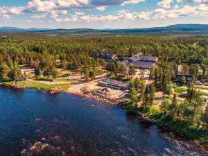 an aerial view of a resort next to a river at Harriniva Adventure Resort Cabins in Muonio