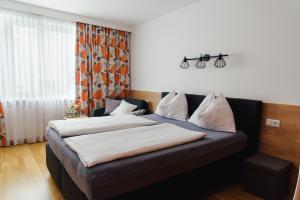 a hotel room with two beds and a window at Hotel Drei Kreuz - Self Check In in Salzburg