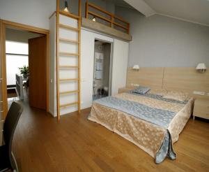 a bedroom with a bed and a loft bed at Namai pas Gintarą in Palanga