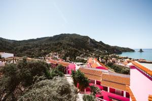 a view of a town and the ocean at Pink Palace Beach Resort in Agios Gordios