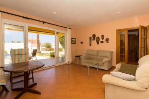a living room with a couch and a table at Sa Tramuntana in Cala en Blanes