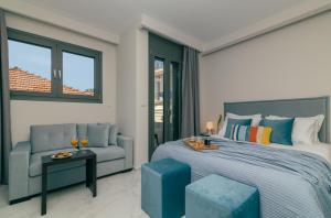 a bedroom with a king sized bed and a chair at Centro Studios & Apartments in Zakynthos