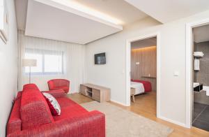 TV a/nebo společenská místnost v ubytování Essence Inn Marianos Hotel