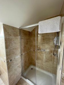 a shower with a glass door in a bathroom at Glasha Meadows Accommodation in Doolin