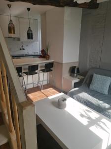 a living room with a couch and a kitchen at Côté Dyle de la Tourelle in Ways