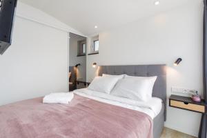 a bedroom with a large bed with white pillows at Villa Aia Apartment in Pärnu
