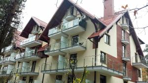 a large building with balconies on the side of it at APARTAMENT NATALKA przy plaży in Krynica Morska