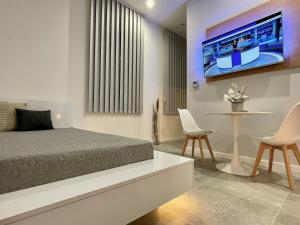 a bedroom with a bed and a table and chairs at Bogáthy Kúria Business Apartments in Nyírbogát