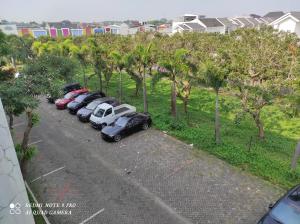 a row of cars parked in a parking lot at Comfy Emerald Hill Karawang in Telukjambe +2 photos