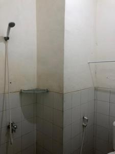 a bathroom with a shower and a toilet in it at Comfy Emerald Hill Karawang in Telukjambe