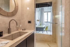 a bathroom with a sink and a shower at Milan Royal Suites - Centro in Milan +255 photos