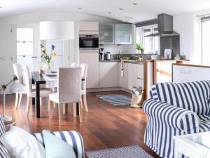 a kitchen and living room with a table and chairs at Watervilla in Loosdrecht