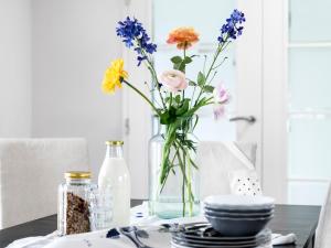 a vase filled with flowers sitting on a table at Watervilla in Loosdrecht