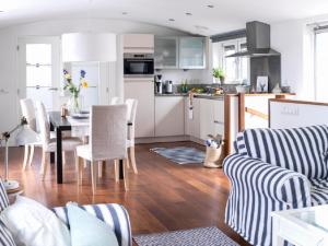 a kitchen and living room with a table and chairs at Watervilla in Loosdrecht +28 photos