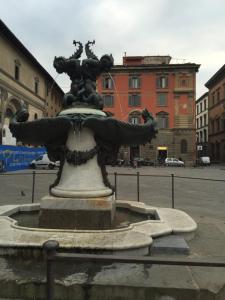 a statue of a man sitting on top of a fountain at Hotel Le Due Fontane in Florence