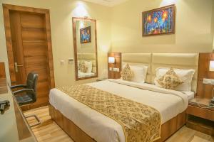 a hotel room with a bed and a mirror at Hotel Hira Inn-10mins From Railway Station & Bus Station in Allahābād