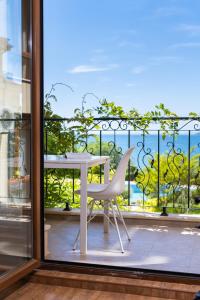 a table and chairs in front of a window at Royal Bay - Beachfront Apartments with Self Check-In in Sveti Vlas