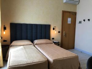 Postel nebo postele na pokoji v ubytování Hotel Tirrenia