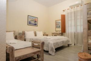 A bed or beds in a room at Akrotiri B&B