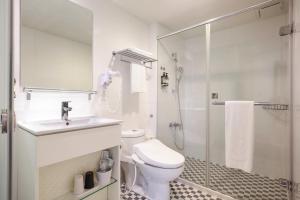 a bathroom with a toilet and a sink and a shower at CityInn Hotel Taipei Station Branch II in Taipei +42 photos