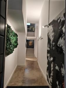 a hallway with white walls and a door with plants at FERIA MODERN y LUXURY in Seville