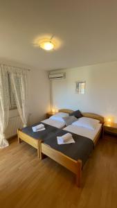 a bedroom with two beds and two windows at Vila Anica in Barbat na Rabu +68 photos