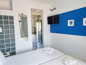 a room with a white bed and a blue wall at Casa Di Estella in Neos Marmaras