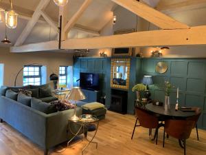 a living room with a couch and a table at Stownes in Stow on the Wold