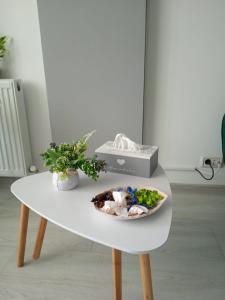 a white table with a plate of food on it at Studio Timeea Mamaia-Nord in Năvodari