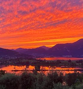 a sunset over a lake with mountains in the background at Agriturismo Forest in Iseo