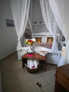 a room with a white bed and a white table at Mare Nostrum Santo in Oia