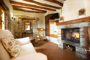 a living room with a couch and a fireplace at El Corral de Villacampa in Mondot