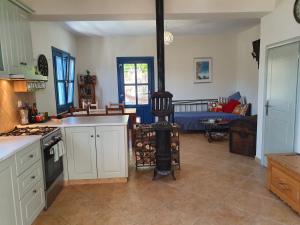 a kitchen with white cabinets and a stove top oven at Villa Orea Thea, Emborios, Kalymnos in Emborios Kalymnos +25 photos