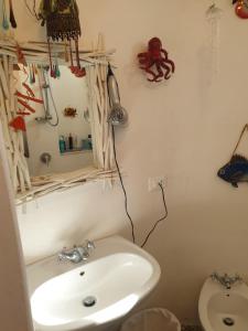a bathroom with a white sink and a toilet at Casa Le Due Sicilie in Panarea +42 photos