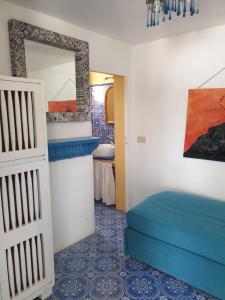 a bedroom with a bed and a mirror and a sink at Casa Le Due Sicilie in Panarea