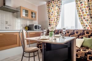 a kitchen with a table with wine glasses on it at Апартаменты in Yekaterinburg