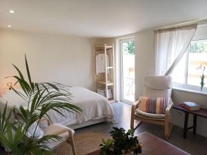 a bedroom with a bed and a desk and a chair at Pateo Estoril - Brand New Villa in Estoril in Estoril