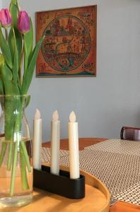 un grupo de velas en una mesa con un jarrón de flores en Apartment Pension Sternchen, en Erfurt