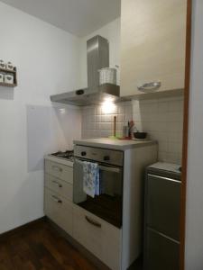 a small kitchen with a stove and a sink at LA VALLETTA SUL MARE in La Spezia