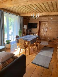 a dining room with a large wooden table and chairs at Chata Leona in Gorlice