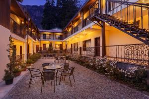 a patio with tables and chairs in a building at The Earls Court by Leisure Hotels in Nainital