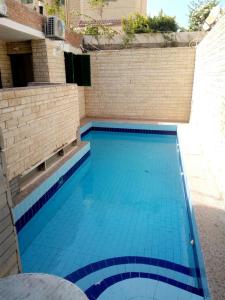 a large swimming pool with blue water at 1B studio 2beds air conditioned basement114 green beach in El Alamein