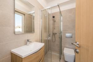 a bathroom with a toilet and a sink and a shower at Holiday House Lavanda in Vrsi +40 photos